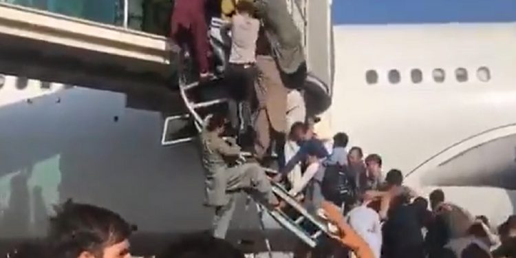 Hundreds jostle to board planes- desperate scenes at Kabul airport.