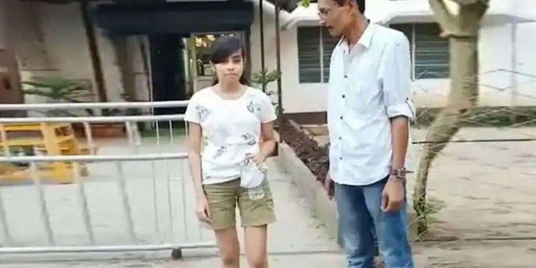 19-year-old in shorts made to take exam wrapped in curtain