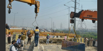 Police dismantle barricades from the Ghazipur farmers’ protest site following a Supreme Court decision